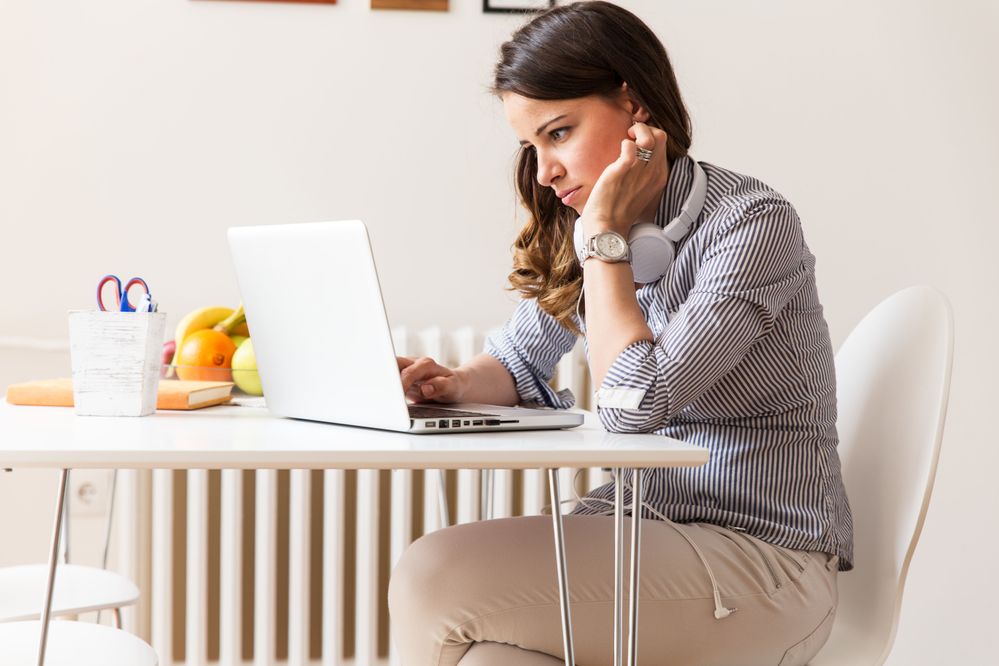 82838872_attractive_woman_looking_at_laptop.jpeg