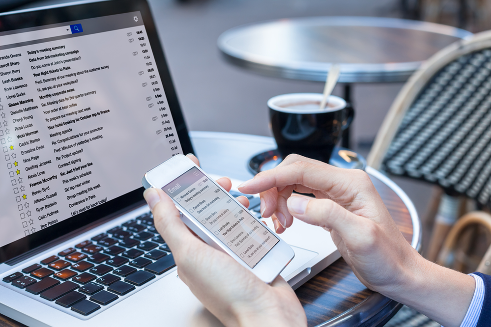 lady-on-phone-looking-at-emails.png