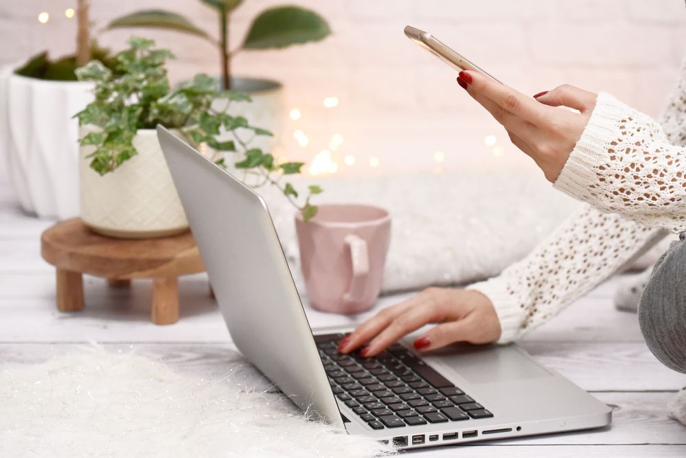 Lady using laptop and mobile phone
