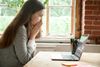 Lady looking at laptop in distress