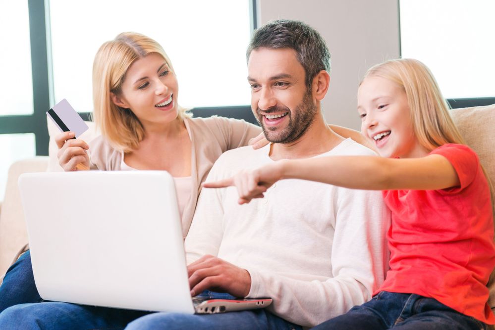 Family on sofa with laptop