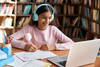 Girl wearing headphones sat with laptop