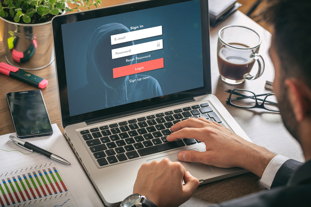 Male-with-laptop-showing-login-screen